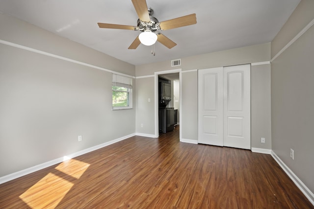 unfurnished bedroom with ceiling fan, visible vents, baseboards, and wood finished floors
