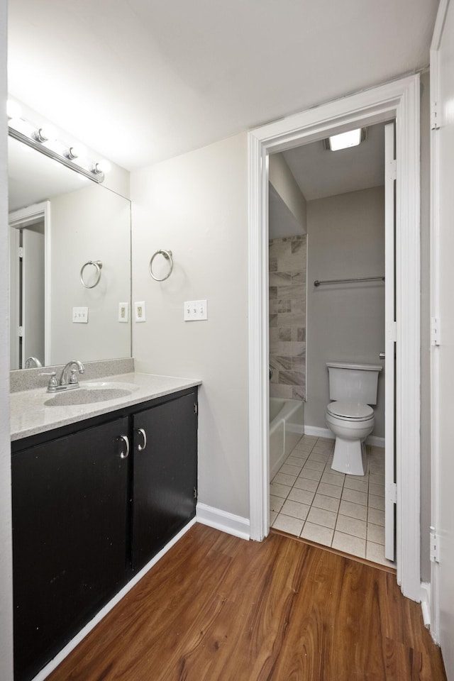 full bathroom featuring tile patterned floors, toilet, vanity, and baseboards