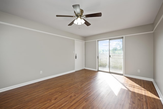spare room with ceiling fan, baseboards, and wood finished floors