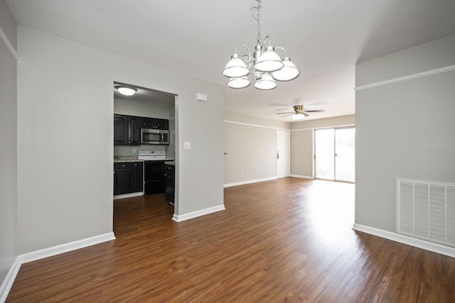unfurnished dining area with visible vents, ceiling fan with notable chandelier, baseboards, and dark wood finished floors