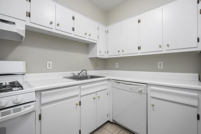 kitchen with white appliances, light countertops, white cabinetry, under cabinet range hood, and a sink