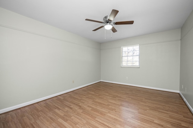 unfurnished room featuring light wood-type flooring, baseboards, and a ceiling fan