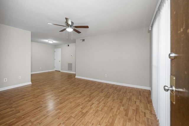 unfurnished room featuring light wood-style flooring, ceiling fan, baseboards, and visible vents