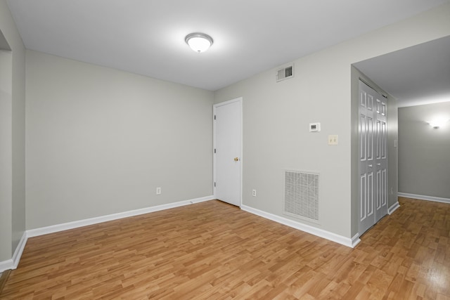 unfurnished room with visible vents, baseboards, and light wood-style floors