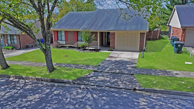 single story home featuring brick siding, a front lawn, fence, and an attached garage