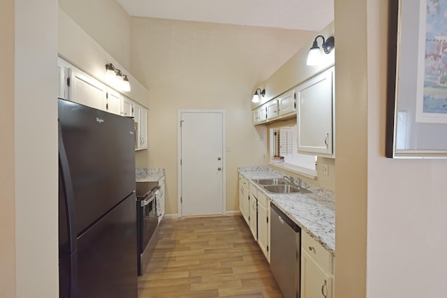 kitchen featuring baseboards, a sink, light wood-type flooring, white cabinetry, and stainless steel appliances