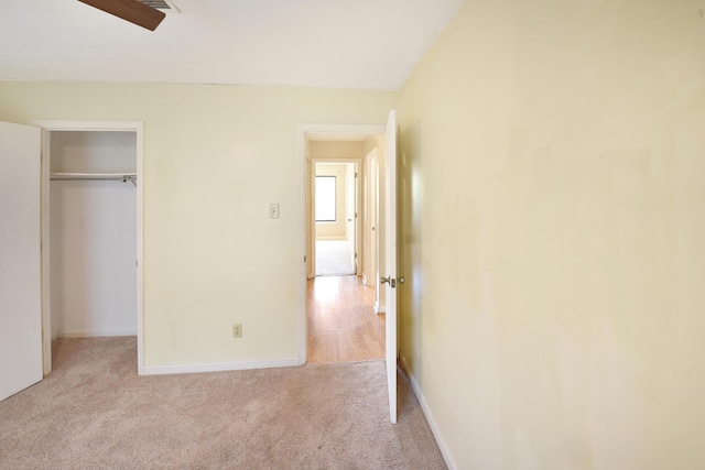 unfurnished bedroom featuring a closet, baseboards, and carpet