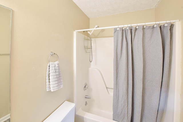 full bath featuring shower / bath combination with curtain and a textured ceiling