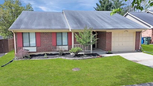 single story home with an attached garage, concrete driveway, a front lawn, and brick siding