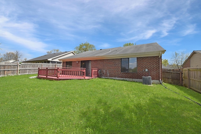 back of property featuring central air condition unit, a yard, a fenced backyard, and brick siding