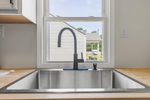 room details featuring a sink and wood counters