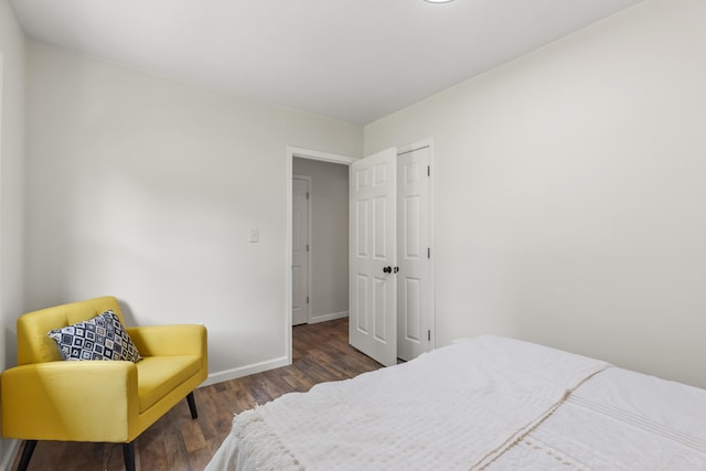 bedroom with baseboards and dark wood finished floors
