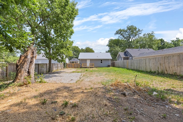 view of yard with a fenced backyard and a deck