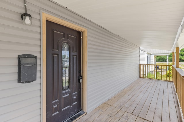 view of exterior entry with covered porch