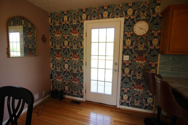 312 Springhurst Dr, Berea, KY 40403 - doorway to outside featuring baseboards, wallpapered walls, light wood-style flooring, and a wealth of natural light