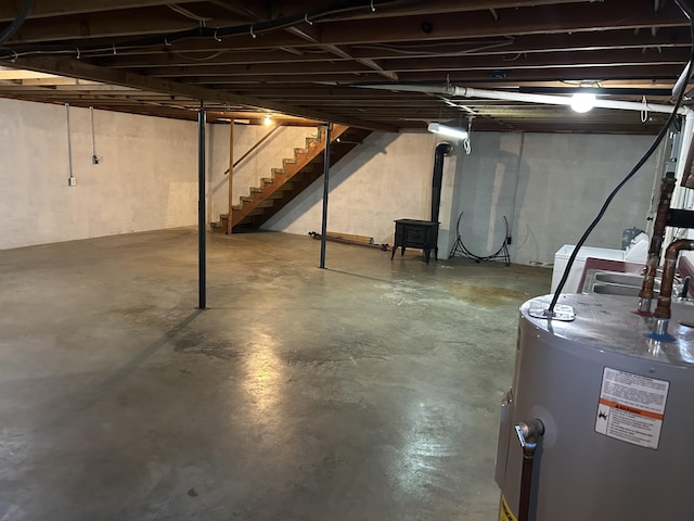 9380 Russell Springs Rd, Russell Springs, KY 42642 - unfinished basement with gas water heater and stairs