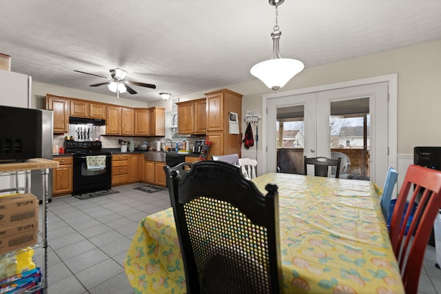 dining area with a ceiling fan, french doors, and light tile patterned floors