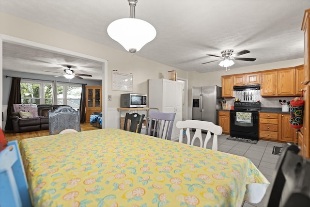 dining area featuring light tile patterned floors and a ceiling fan