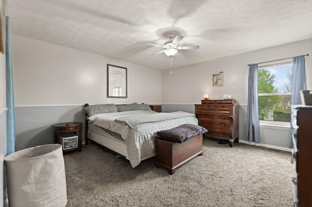 carpeted bedroom featuring a ceiling fan, baseboards, and a textured ceiling