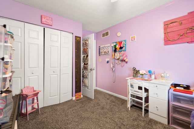 bedroom featuring dark colored carpet, visible vents, and a closet