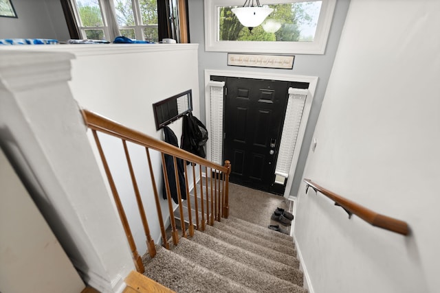 carpeted foyer entrance with stairway