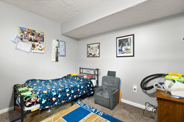 bedroom featuring baseboards and a textured ceiling