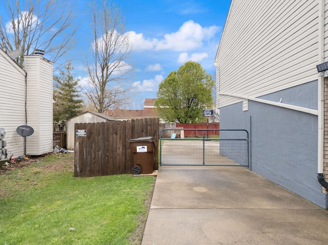view of home's exterior featuring a lawn, a gate, and fence