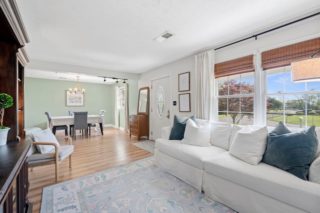 124 Clays Ferry Dr, Richmond, KY 40475 - living room with a healthy amount of sunlight, a chandelier, visible vents, and wood finished floors