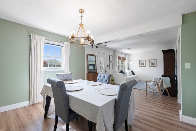 124 Clays Ferry Dr, Richmond, KY 40475 - dining space featuring a textured ceiling, a chandelier, wood finished floors, and baseboards