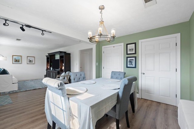 124 Clays Ferry Dr, Richmond, KY 40475 - dining area with rail lighting, a notable chandelier, visible vents, and light wood-style floors