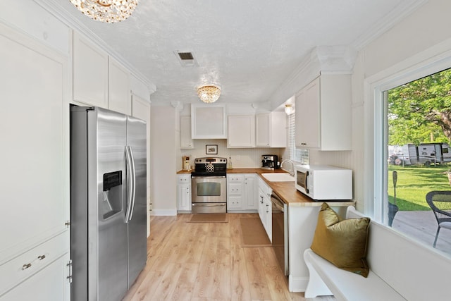 124 Clays Ferry Dr, Richmond, KY 40475 - kitchen with a sink, stainless steel appliances, white cabinetry, wooden counters, and light wood-style floors