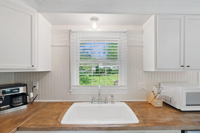 124 Clays Ferry Dr, Richmond, KY 40475 - kitchen with a wealth of natural light, wooden counters, a sink, white microwave, and wood finished floors