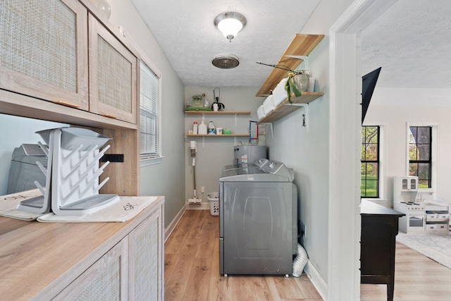 124 Clays Ferry Dr, Richmond, KY 40475 - laundry room with gas water heater, cabinet space, a textured ceiling, washing machine and clothes dryer, and light wood-style flooring