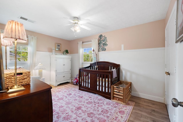 124 Clays Ferry Dr, Richmond, KY 40475 - bedroom featuring a ceiling fan, baseboards, visible vents, wood finished floors, and a crib