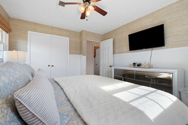 124 Clays Ferry Dr, Richmond, KY 40475 - bedroom featuring a closet, wallpapered walls, a wainscoted wall, and ceiling fan
