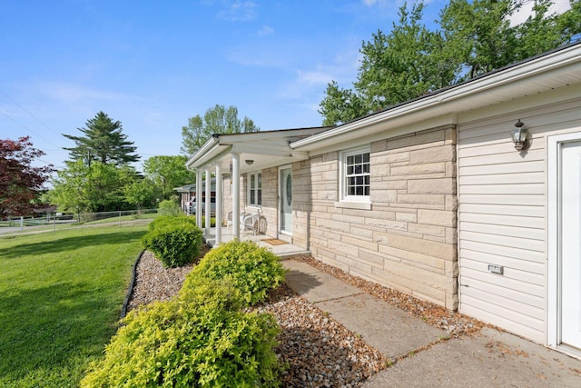 124 Clays Ferry Dr, Richmond, KY 40475 - view of exterior entry featuring a yard, fence, and stone siding