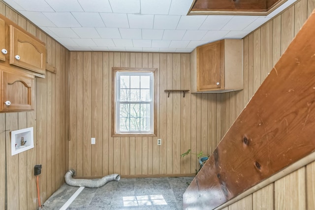 laundry room featuring cabinet space, washer hookup, and wooden walls