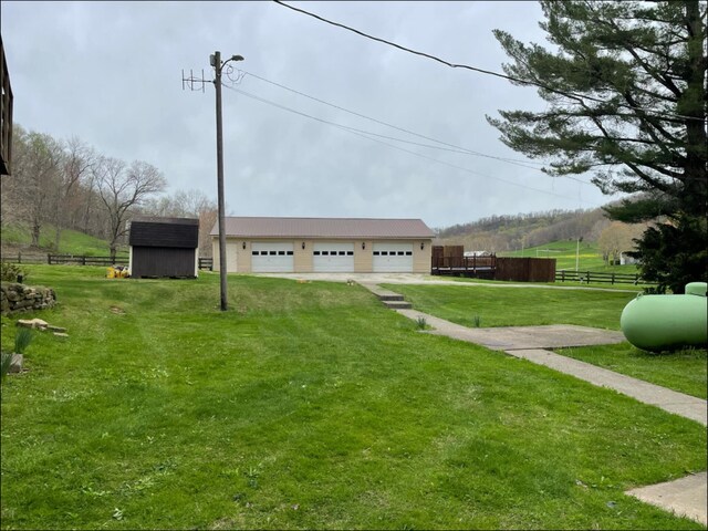 1459 Buck Lick Rd, Tollesboro, KY 41189 - view of yard featuring a detached garage and a storage unit