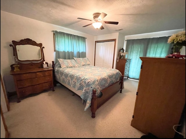1459 Buck Lick Rd, Tollesboro, KY 41189 - bedroom with light carpet, a closet, a textured ceiling, and a ceiling fan