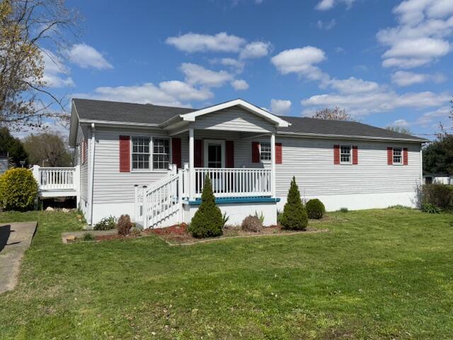 view of front of property with a porch and a front lawn