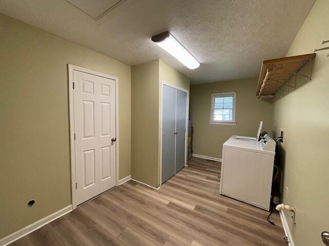 laundry room with baseboards, washer hookup, laundry area, a textured ceiling, and light wood finished floors