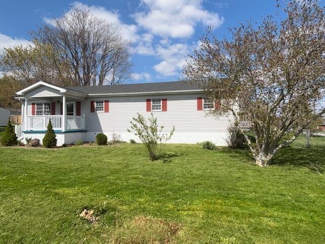 ranch-style home with a front yard and covered porch