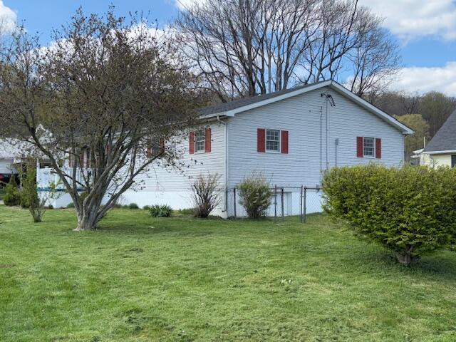 view of home's exterior with a lawn