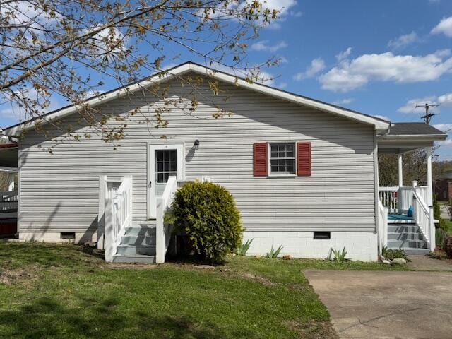 back of house with a yard and crawl space