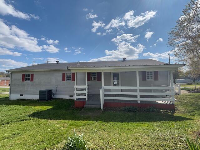 rear view of property featuring crawl space, central AC, a lawn, and covered porch