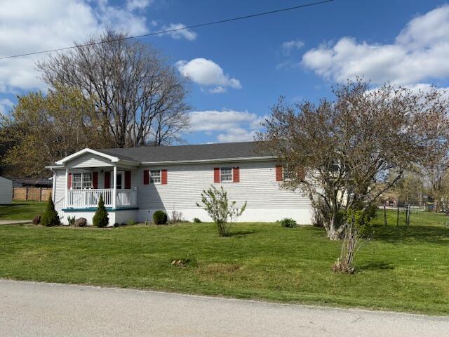 view of front of house with a porch and a front lawn