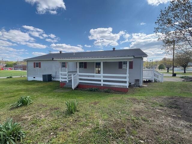 back of property with central air condition unit and a lawn