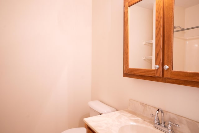 bathroom featuring toilet and vanity