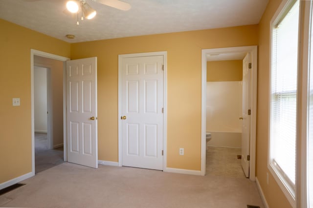 unfurnished bedroom featuring light carpet, visible vents, and baseboards