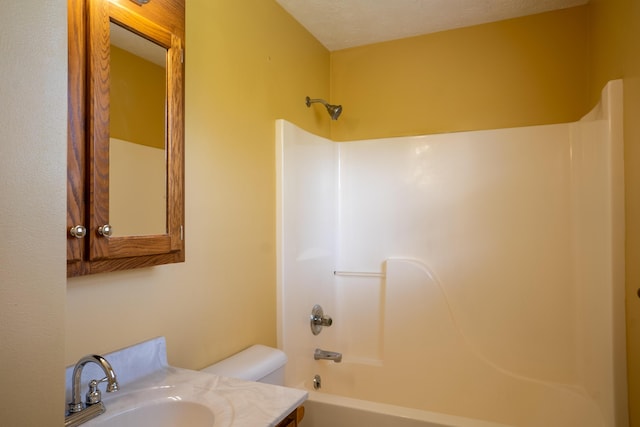 bathroom featuring shower / washtub combination, vanity, and toilet
